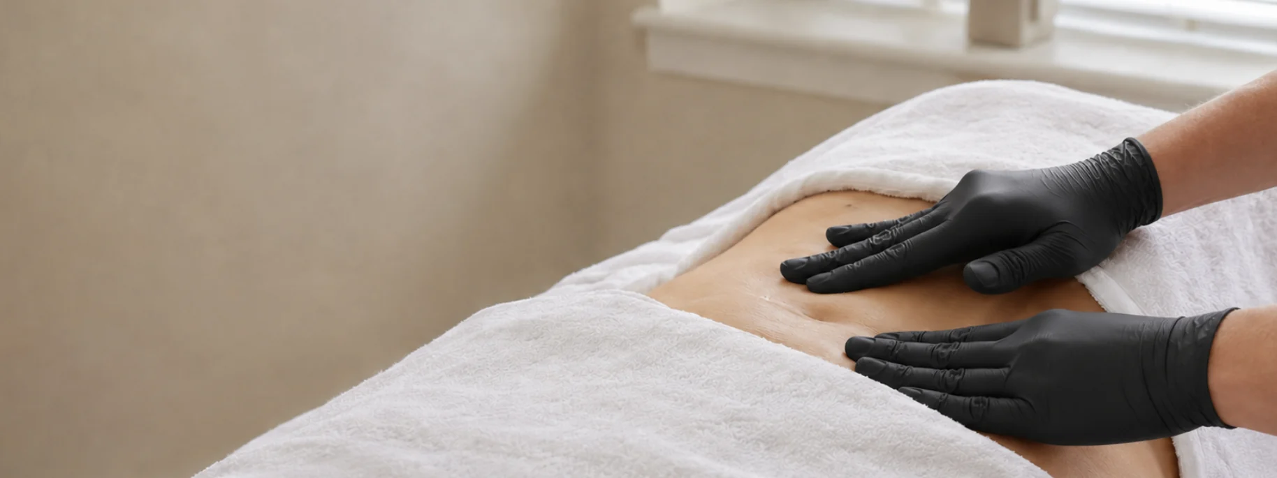 Lymphatic drainage massage being performed in a treatment room