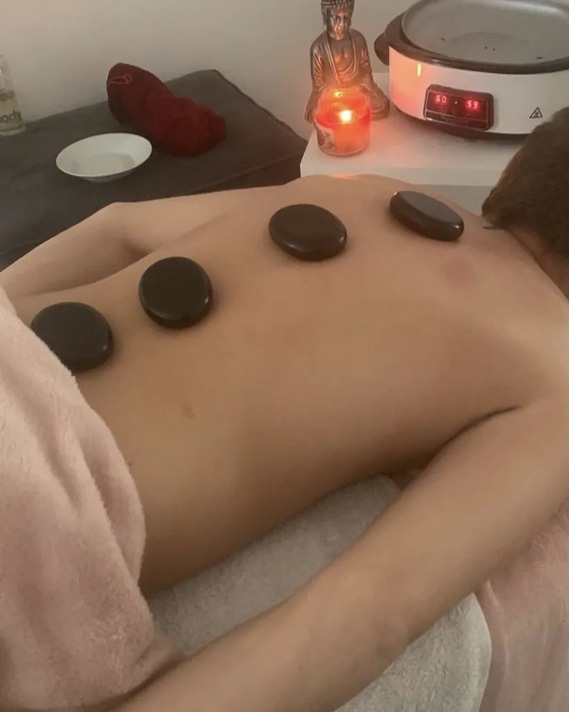 Hot stone massage with heated stones placed along the back
