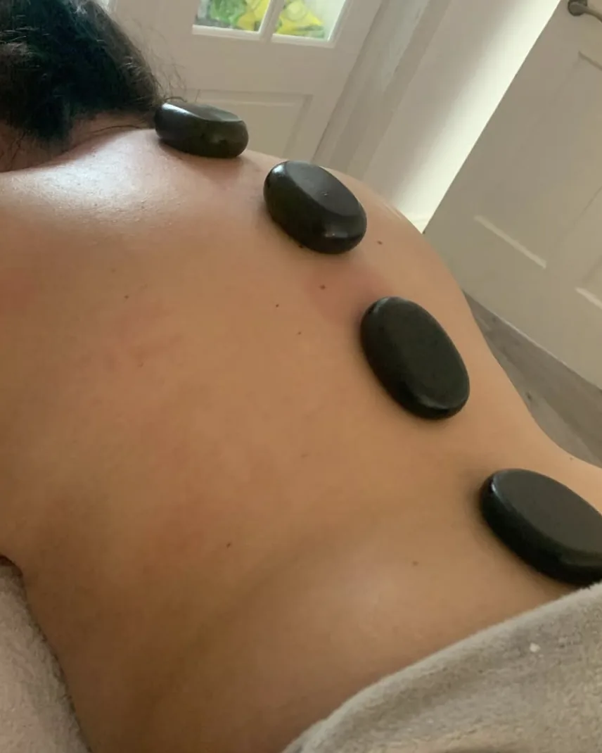 Hot stone massage across the shoulders and upper back
